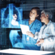 Two healthcare workers looking at hologram of ribs