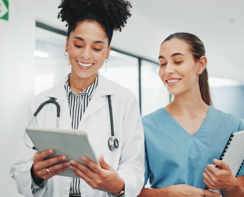 Nurse and doctor looking at tablet