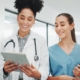 Nurse and doctor looking at tablet