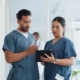 Two healthcare workers looking at tablet