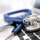 Side view of a stethoscope on top of laptop keyboard