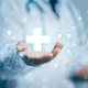 Doctor holding up human anatomy and medical graphic, front view photo edit