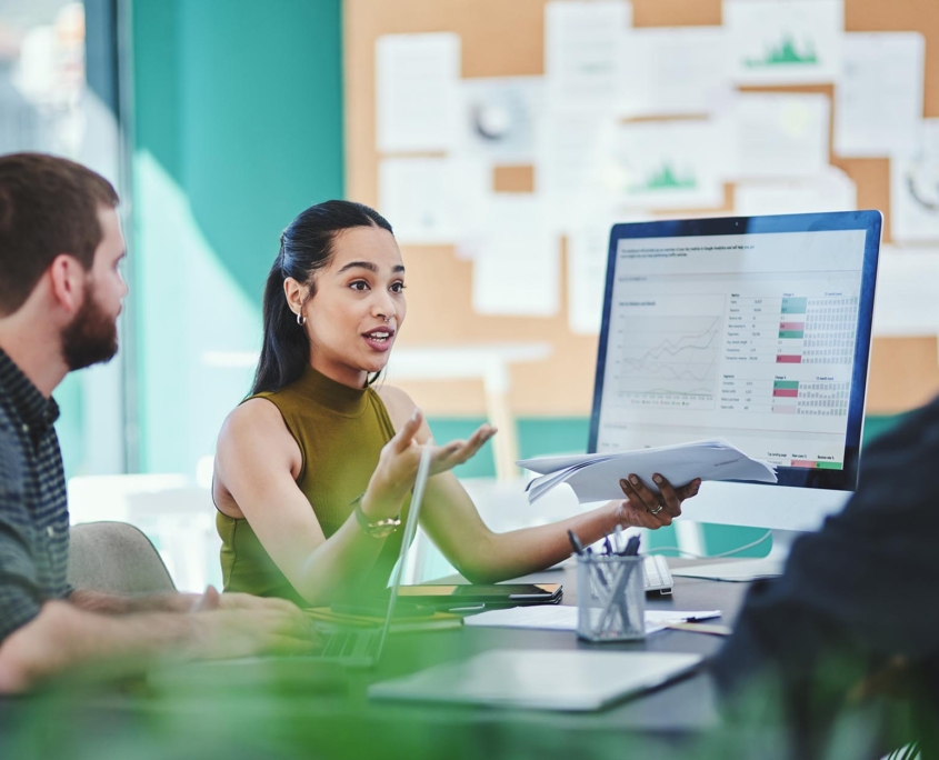 Workers in meeting discussing data management
